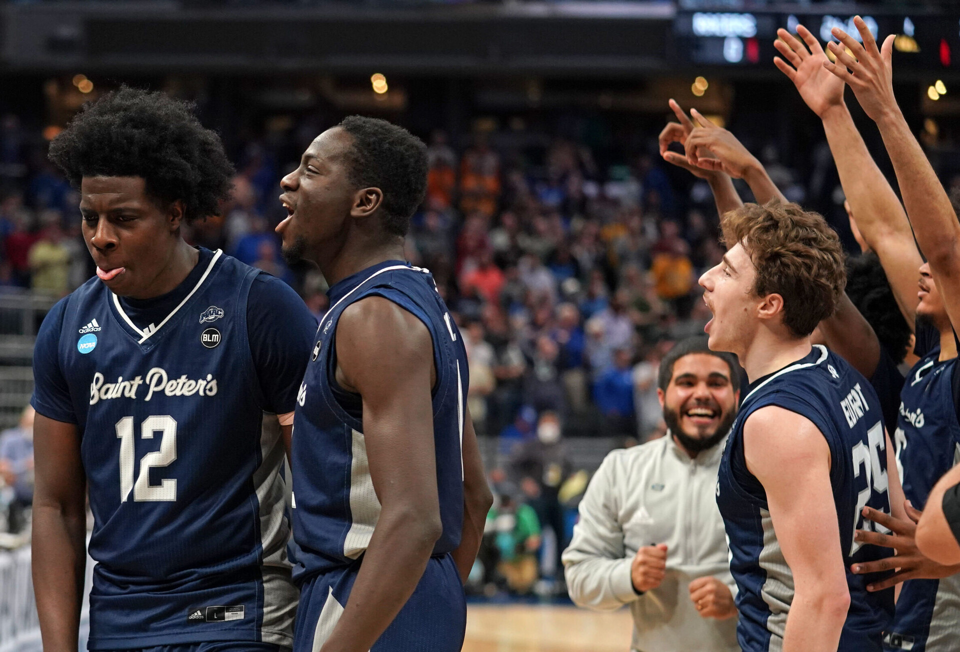 Saint Peter's Peacocks forward Clarence Rupert (far left) and teammates react after defeating the Kentucky Wildcats during the first round of the 2022 NCAA Tournament