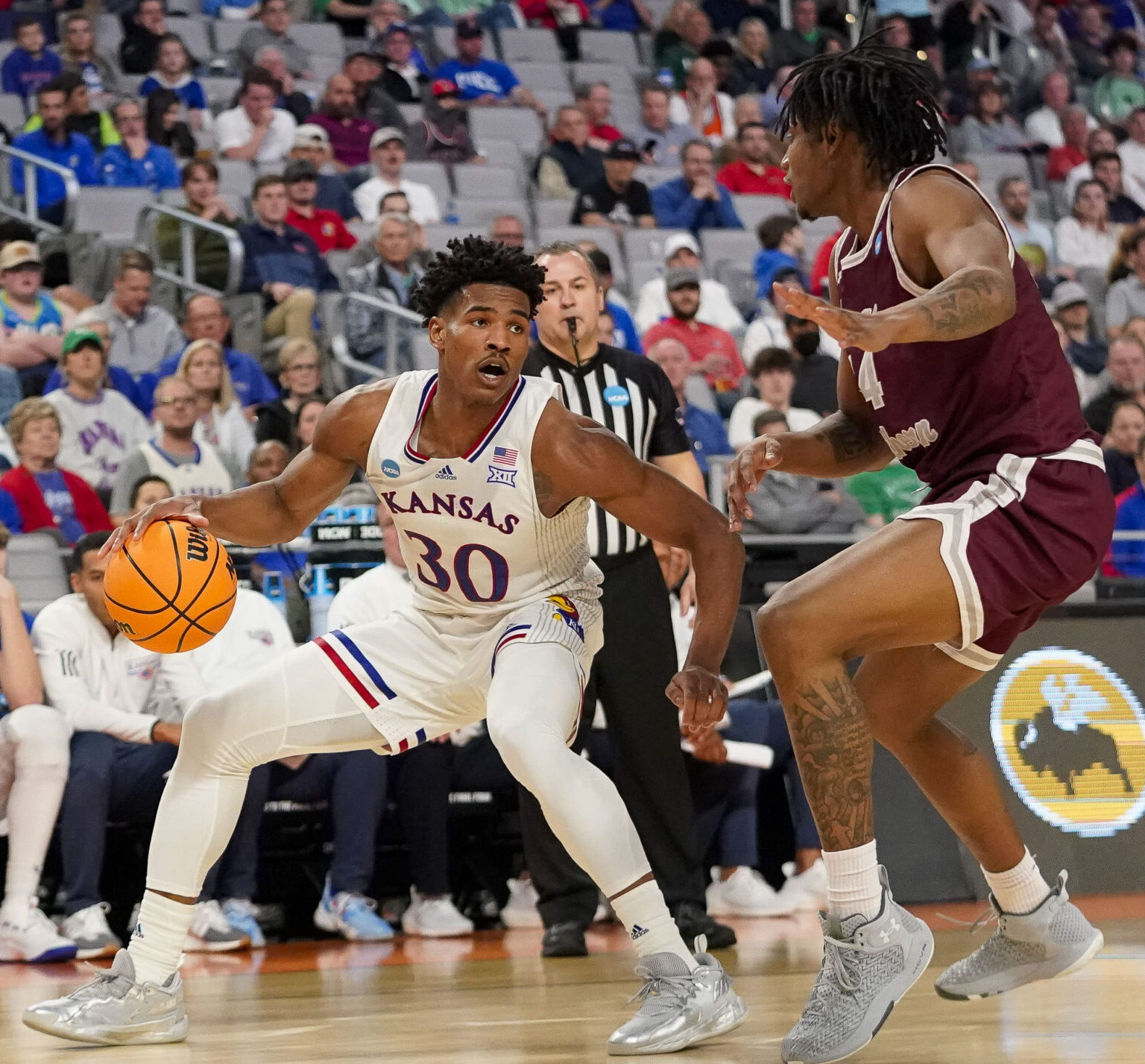 Texas Southern Tigers guard Bryson Etienne (right) guards Kansas Jayhawks guard Ochai Agbaji (left) as Agbaji dribbles the basketball with his left hand during an NCAA Tournament game