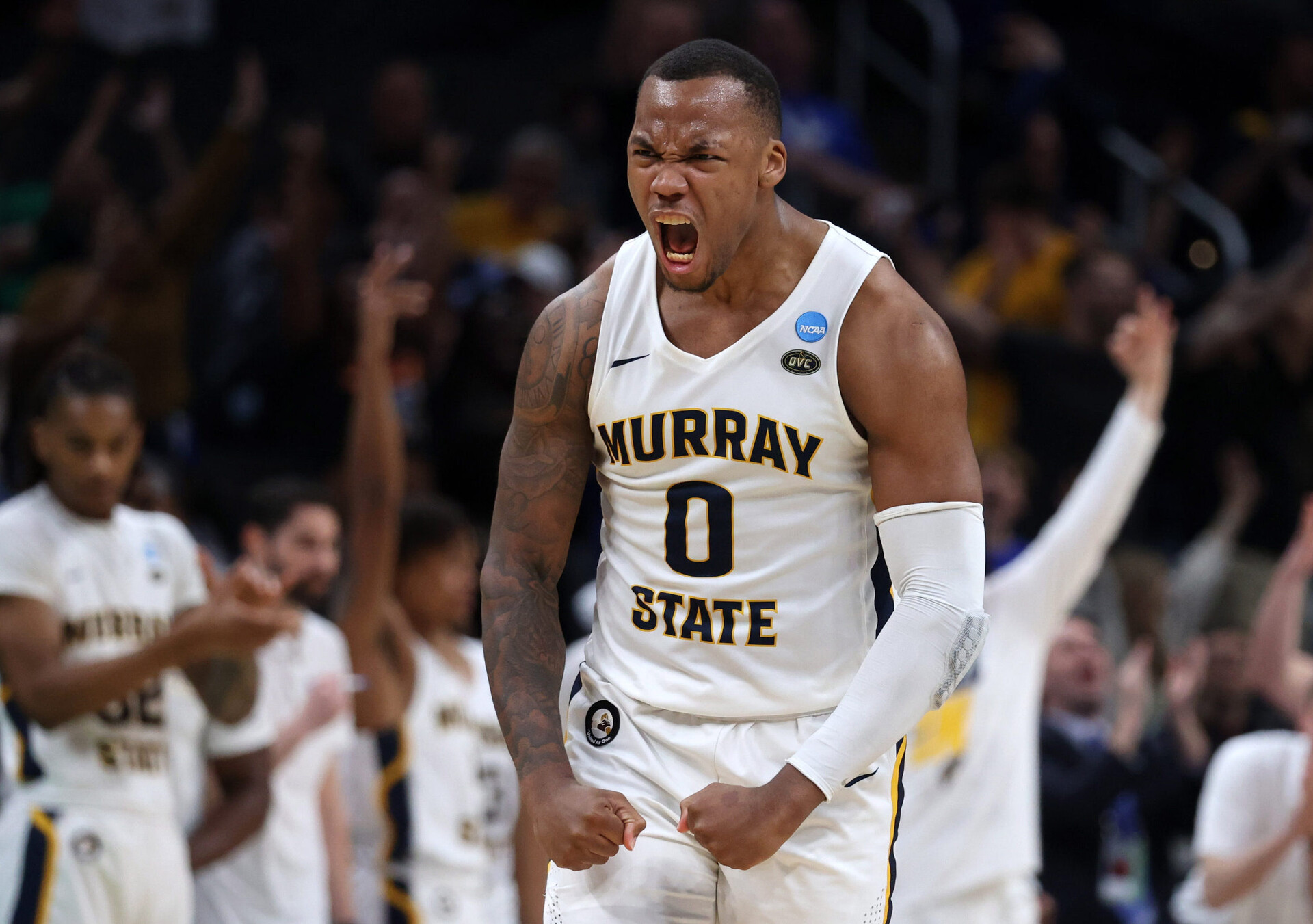 Murray State Racers forward KJ Williams roars and pumps his fists below his waist after a play against the San Francisco Dons during an NCAA Tournament game