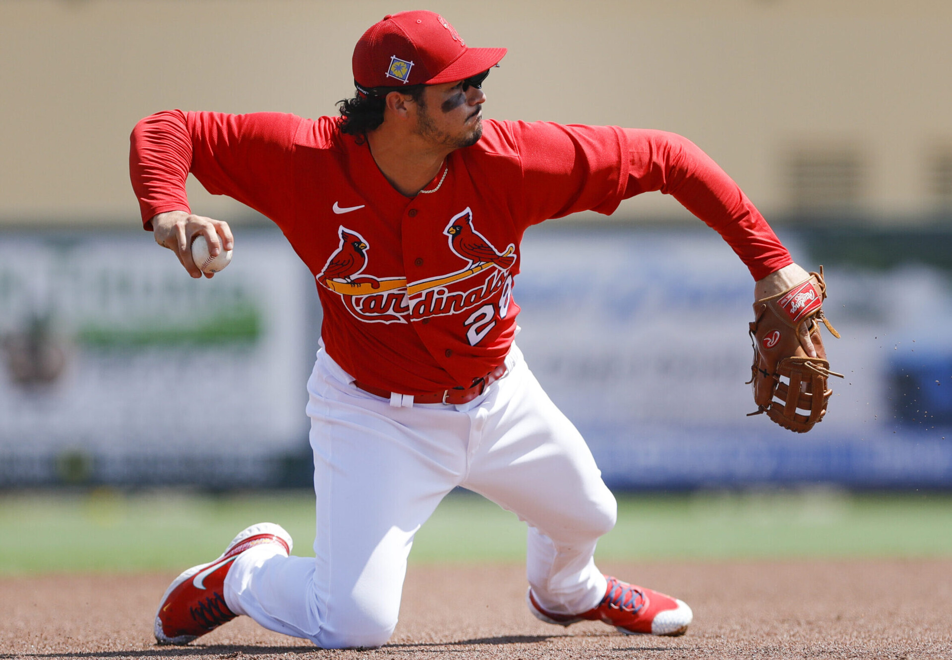 St. Louis Cardinals third baseman Nolan Arenado fields a ball and prepares to throw to first base while on his knees during a spring training game against the Houston Astros