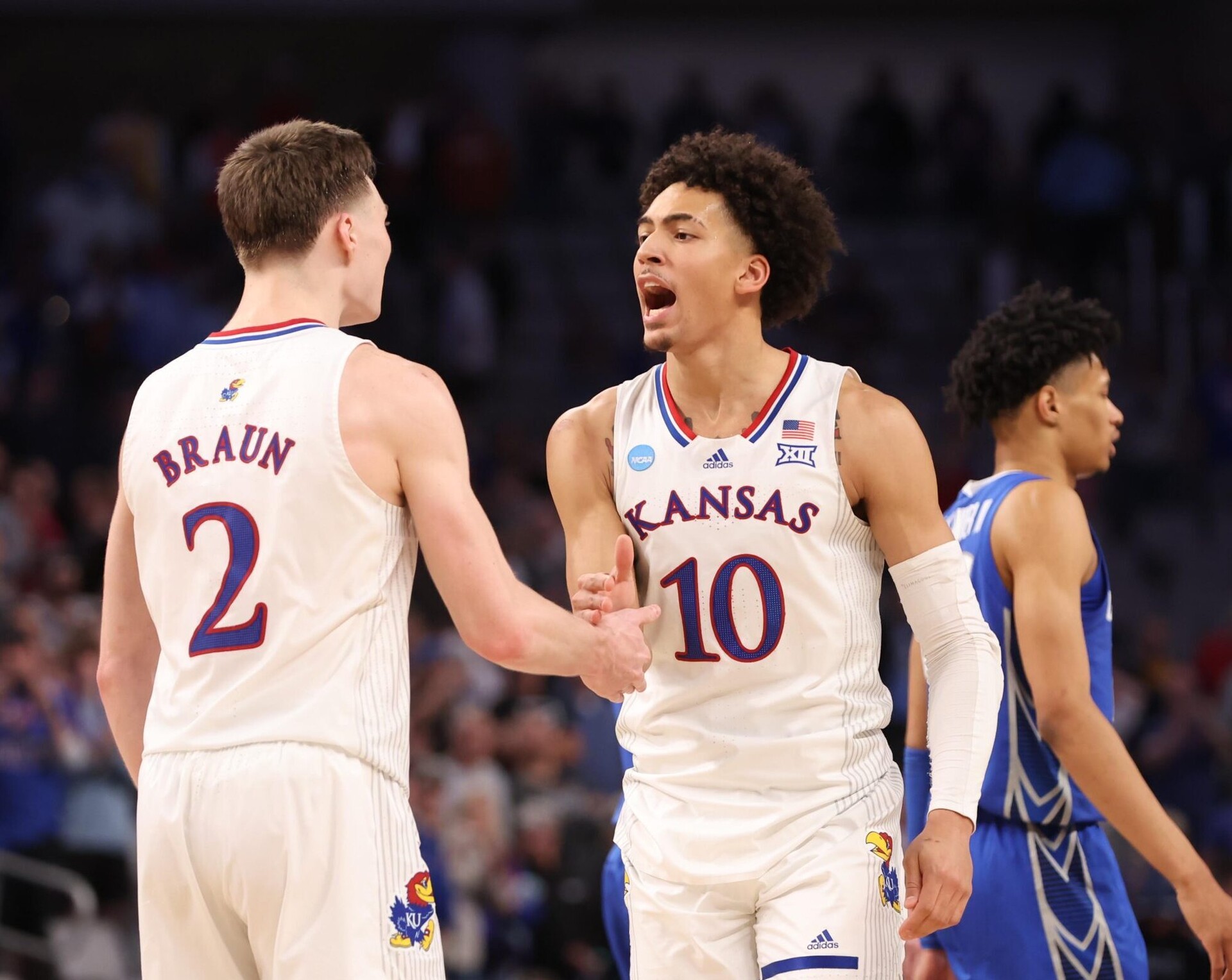 Kansas Jayhawks forward Jalen Wilson (left) and guard Christian Braun (right, back turned) celebrate against the Creighton Bluejays during the second round of the 2022 NCAA Tournament