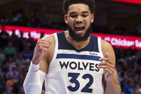 Minnesota Timberwolves center Karl-Anthony Towns pumps his fist and shouts after making a play against the Dallas Mavericks
