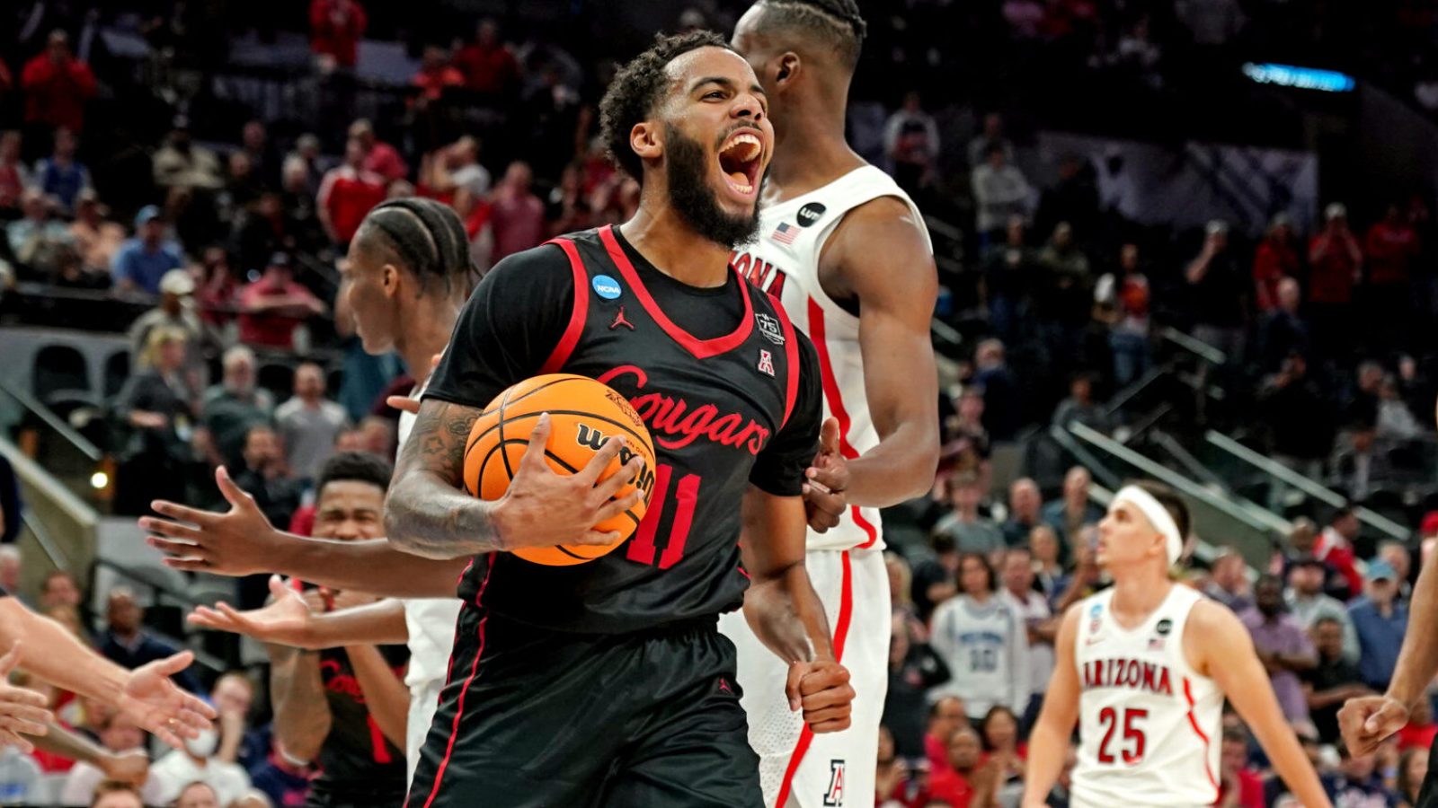 Houston Cougars guard Kyler Edwards (11) reacts during the second half against the Arizona Wildcats in the semifinals of the South regional of the men's college basketball NCAA Tournament at AT&T Center in San Antonio, Texas, on Thursday, March 24.
