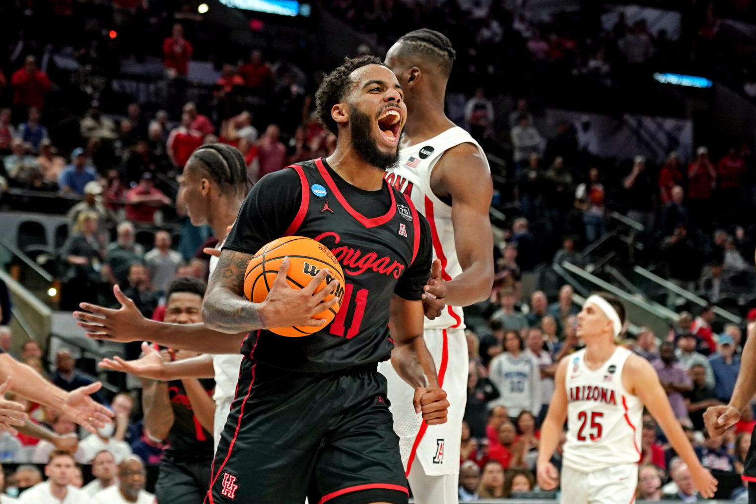 Houston Cougars guard Kyler Edwards (11) reacts during the second half against the Arizona Wildcats in the semifinals of the South regional of the men's college basketball NCAA Tournament at AT&T Center in San Antonio, Texas, on Thursday, March 24.