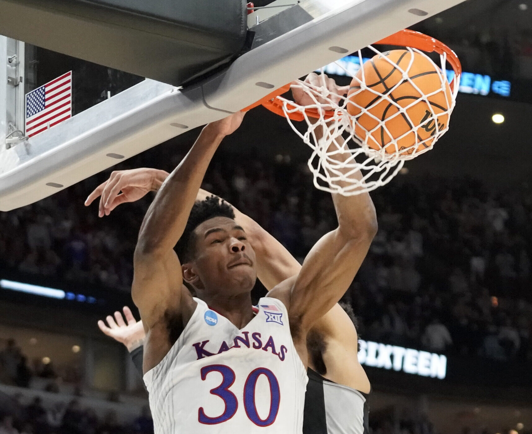 Kansas Jayhawks guard Ochai Agbaji (30) dunks during the second half against the Providence Friars in the semifinals of the Midwest regional of the men's college basketball NCAA Tournament at United Center in Chicago on Friday, March 25, 2022.