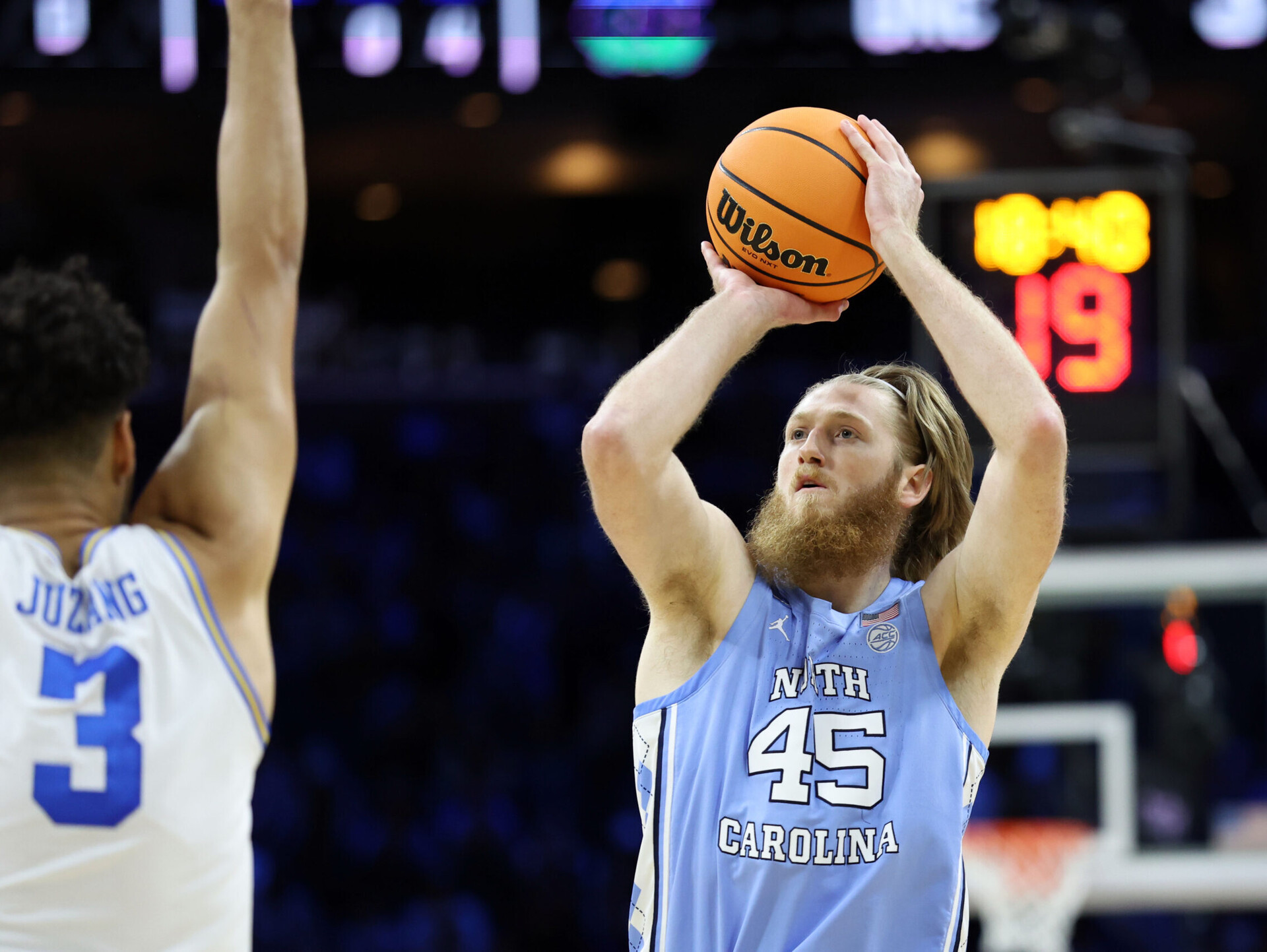 North Carolina Tar Heels forward Brady Manek (right) shoots the basketball with his right hand over defending UCLA Bruins guard Johnny Juzang during an NCAA Tournament Sweet 16 game