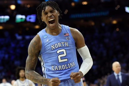 North Carolina Tar Heels guard Caleb Love shouts and pumps his fists after making a play against the UCLA Bruins in the semifinals of the East regional of the men's college basketball NCAA Tournament