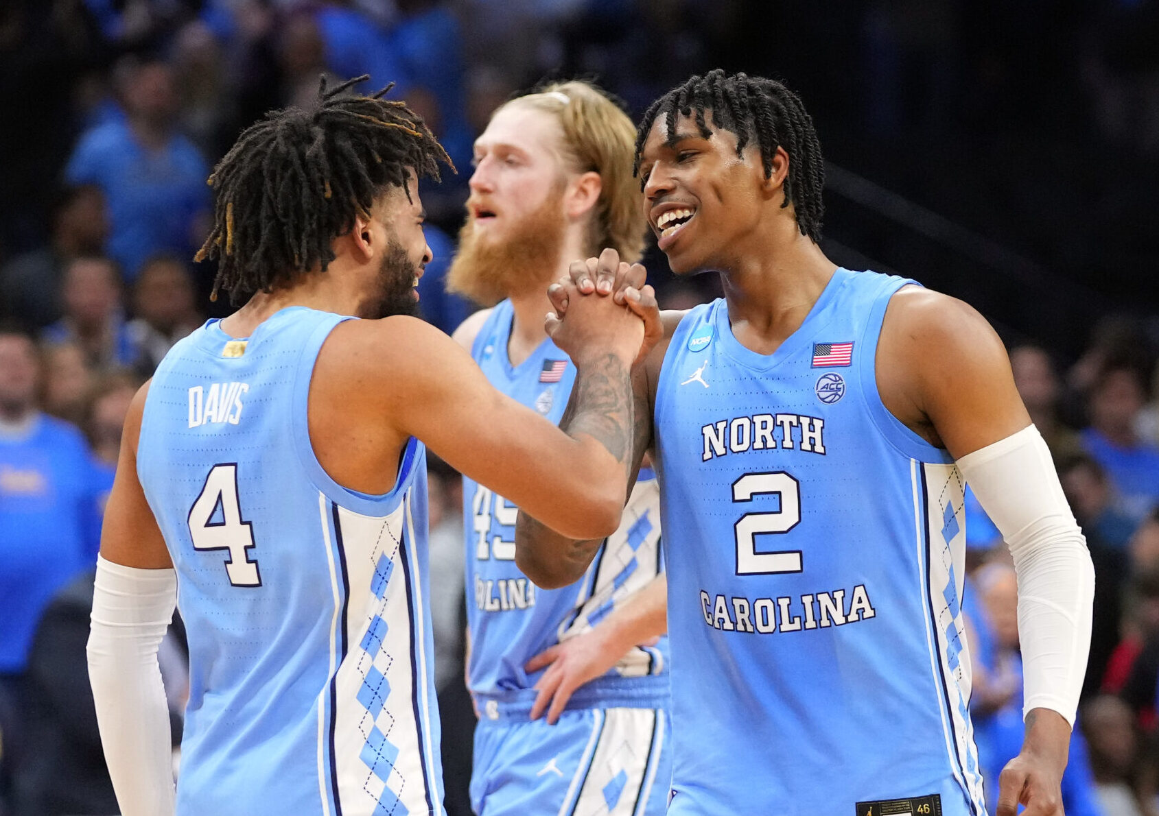 North Carolina Tar Heels guard Caleb Love (2) and guard R.J. Davis (4) celebrate after defeating the UCLA Bruins in the semifinals of the East regional of the men's college basketball NCAA Tournament at Wells Fargo Center in Philadelphia on Friday, March 25, 2022.