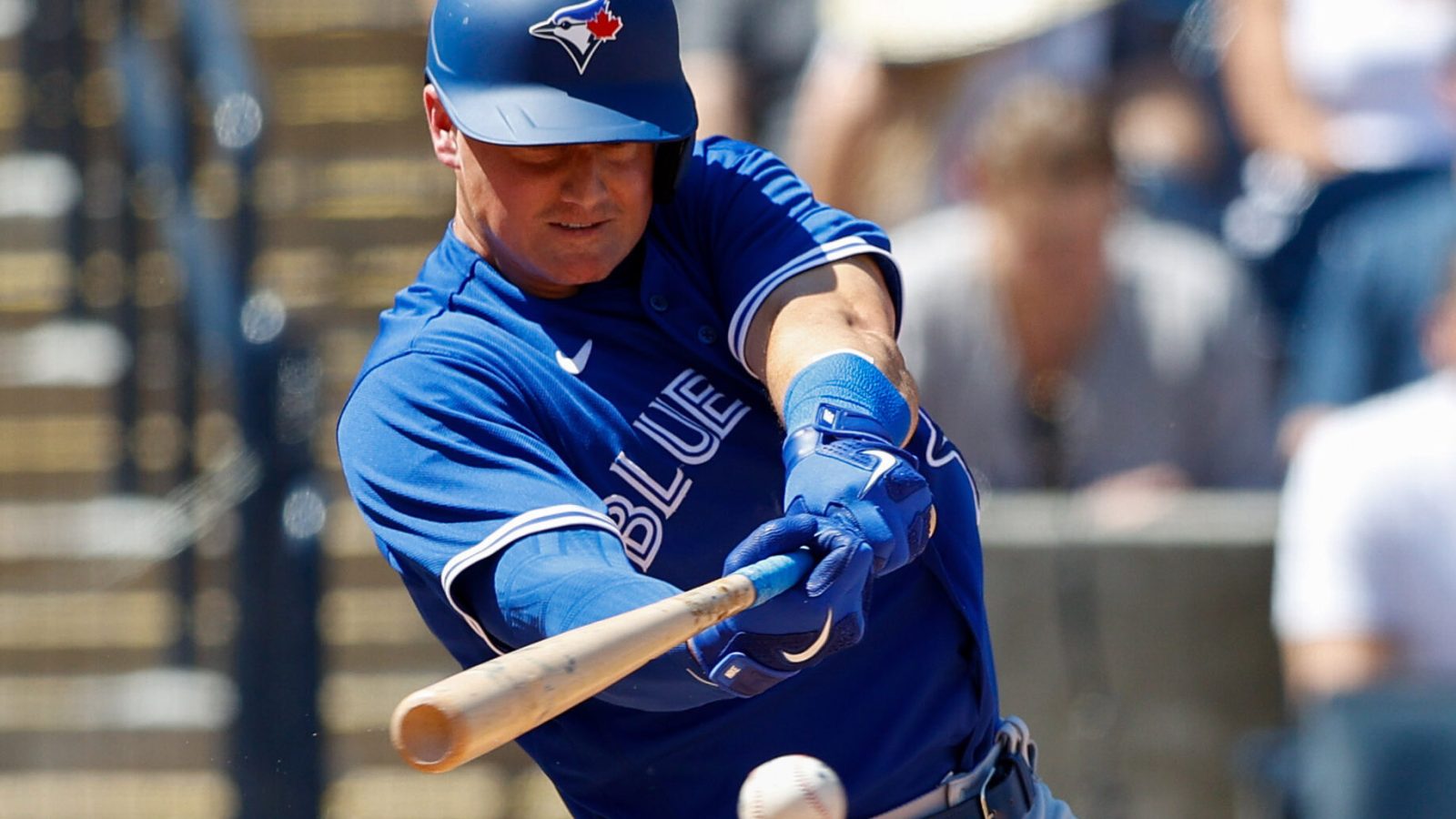 Toronto Blue Jays third baseman Matt Chapman swings at a baseball and gets a base hit in during a spring training game against the New York Yankees