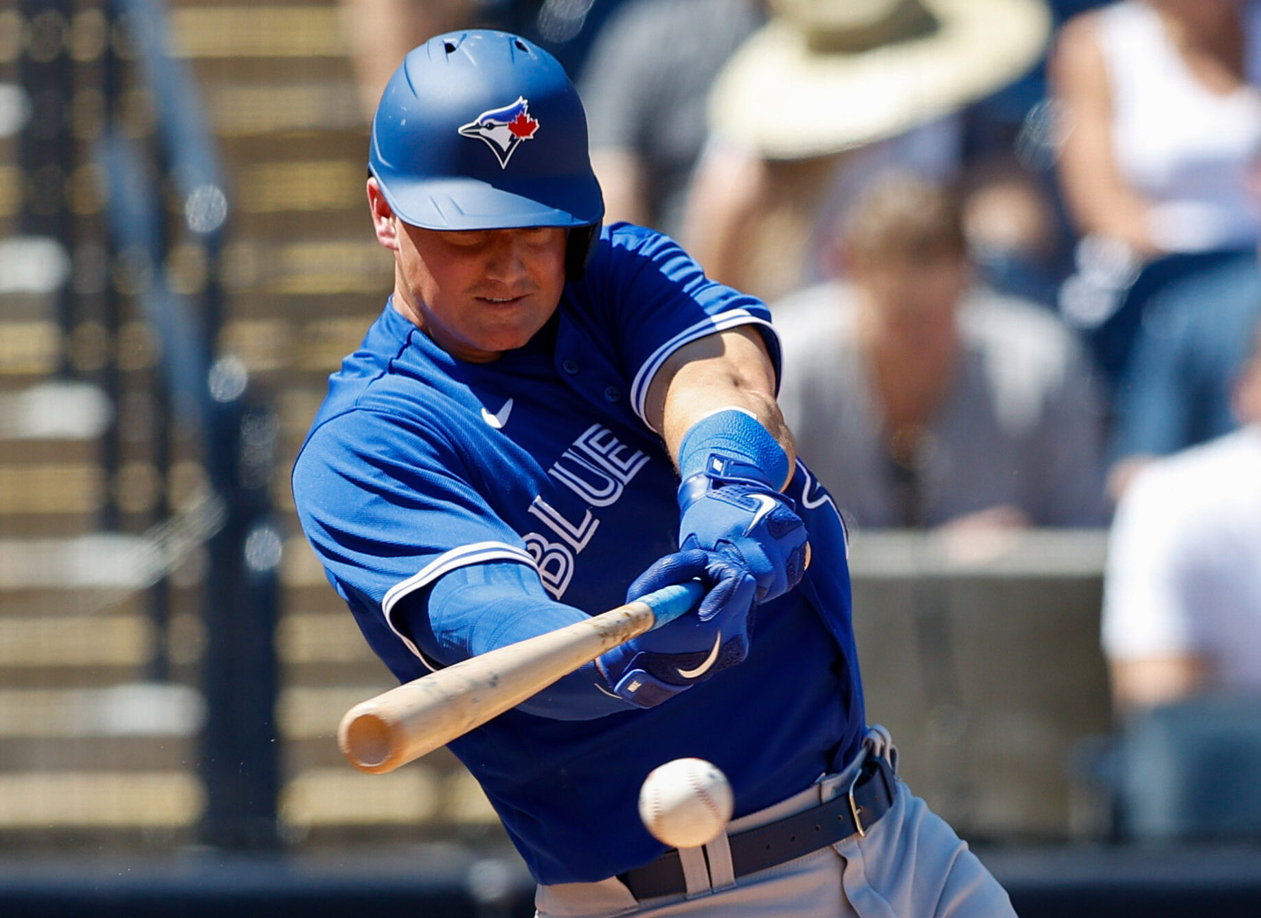 Toronto Blue Jays third baseman Matt Chapman swings at a baseball and gets a base hit in during a spring training game against the New York Yankees