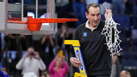 Duke Blue Devils head coach Mike Krzyzewski holds the net as they celebrate their win over the Arkansas Razorbacks in the finals of the West regional of the men's college basketball NCAA Tournament at Chase Center. The Duke Blue Devils won 78-69 at Chase Center in San Francisco on Saturday, March 26, 2022.