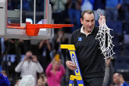 Duke Blue Devils head coach Mike Krzyzewski holds the net as they celebrate their win over the Arkansas Razorbacks in the finals of the West regional of the men's college basketball NCAA Tournament at Chase Center. The Duke Blue Devils won 78-69 at Chase Center in San Francisco on Saturday, March 26, 2022.