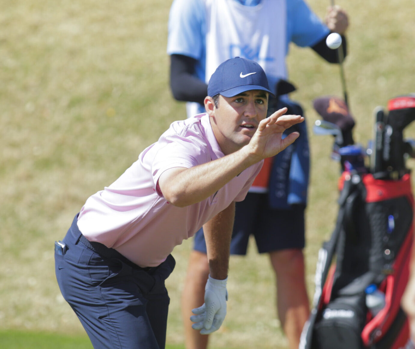 Scottie Scheffler catches his ball from Dustin Johnson on the 11th hole and beat Johnson in the semifinal round of the World Golf Championships-Dell Technologies Match Play golf tournament in Austin, Texas.