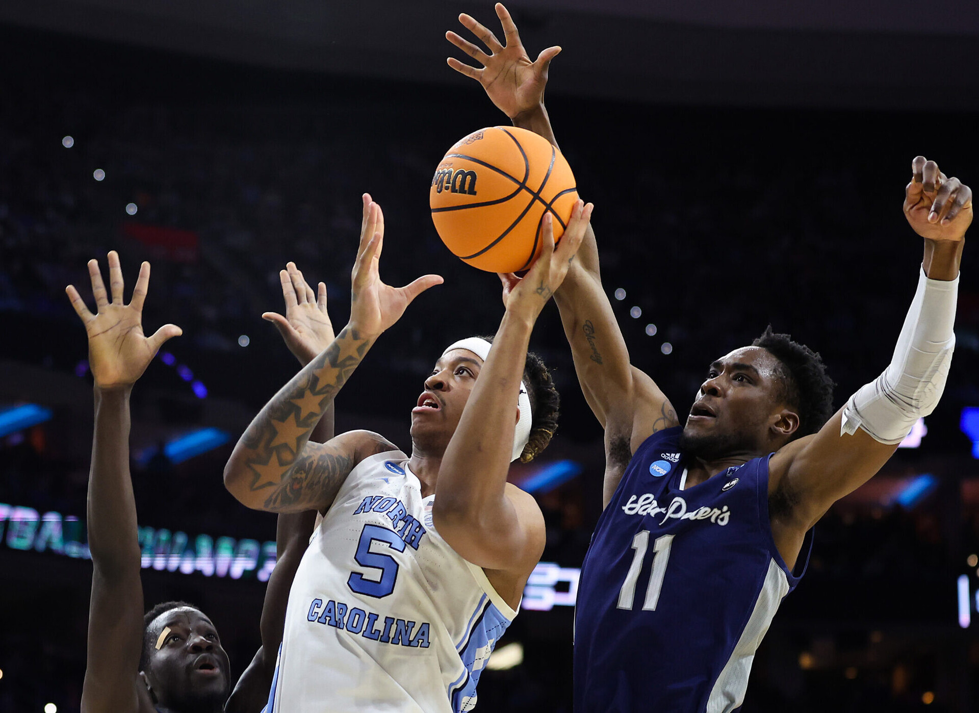 North Carolina Tar Heels forward Armando Bacot (5) shoots against St. Peters Peacocks forward Fousseyni Drame (10) and forward KC Ndefo (11) during the first half in the finals of the East regional of the men's college basketball NCAA Tournament at Wells Fargo Center in Philadelphia on Sunday, March 27, 2022.