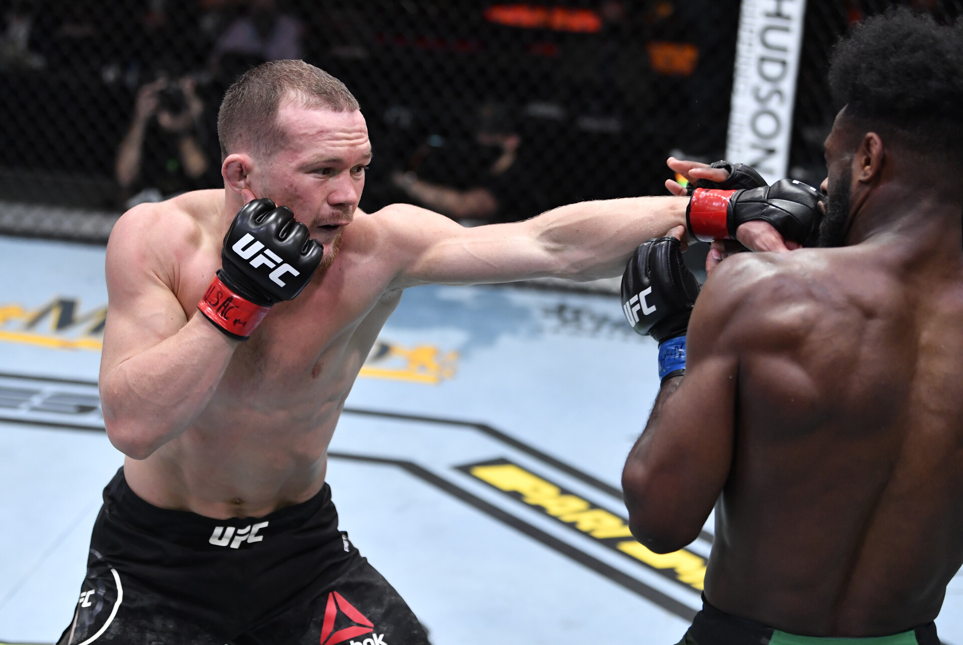 Petr Yan (left) throws a left-handed jab at the face of opponent Aljamain Sterling (right) in their UFC bantamweight championship fight during UFC 259