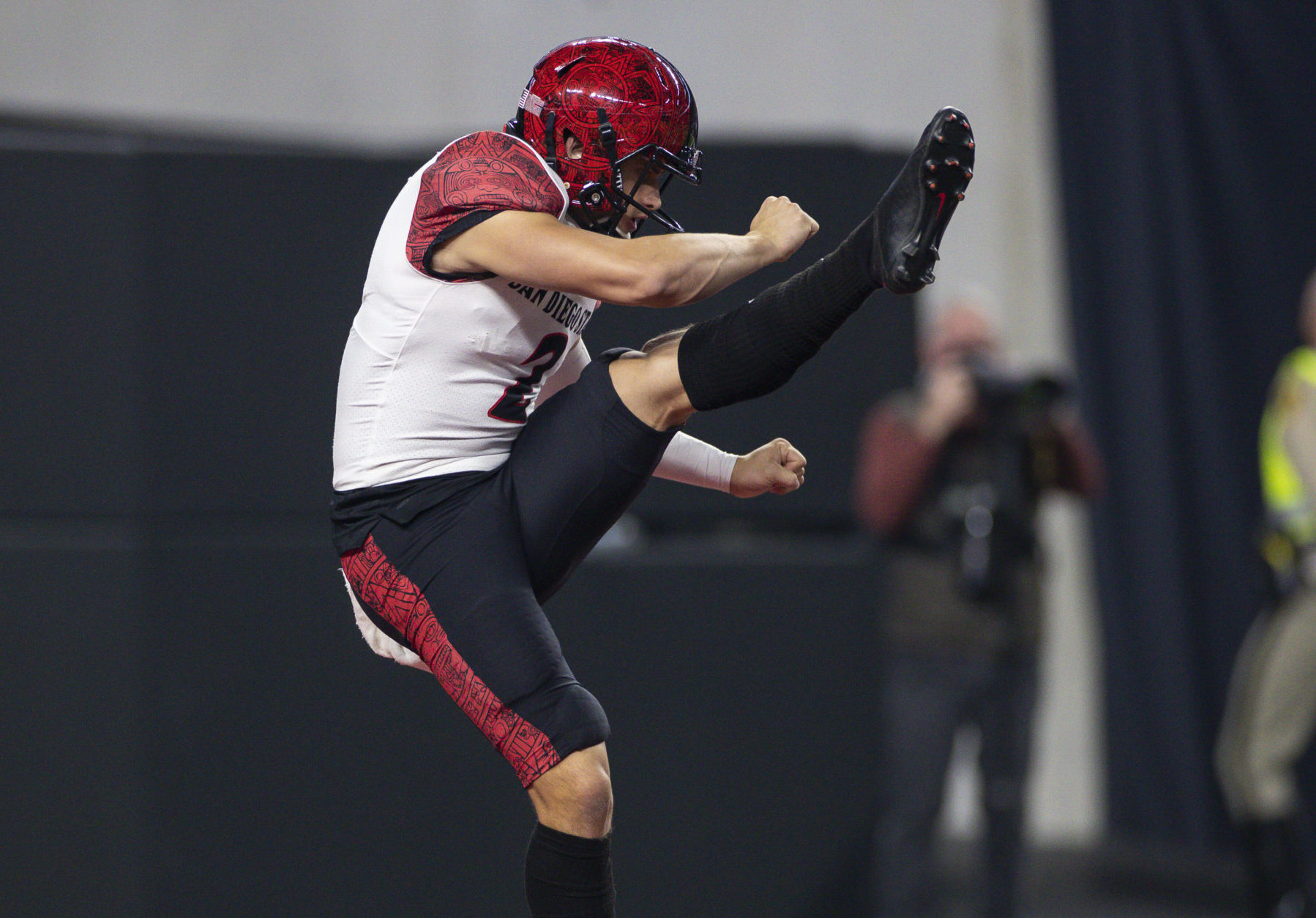 San Diego State Aztecs kicker Matt Araiza swings his left leg high in the air while following through after punting the ball during a game against the UNLV Rebels