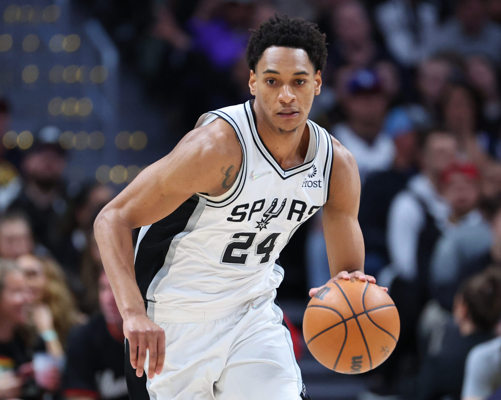 Devin Vassell #24 of the San Antonio Spurs handles the ball against the Denver Nuggets during the second quarter at Ball Arena on April 5, 2022 in Denver, Colorado.