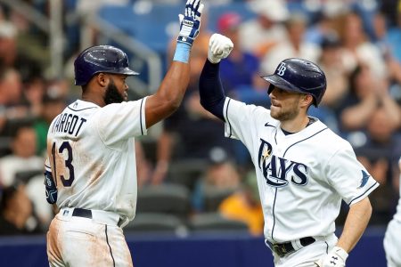 Manuel Margot #13 of the Tampa Bay Rays congratulates Brandon Lowe #8 after his two-run home run against the Oakland Athletics in the seventh inning of a baseball game at Tropicana Field on April 14, 2022 in St. Petersburg, Florida.