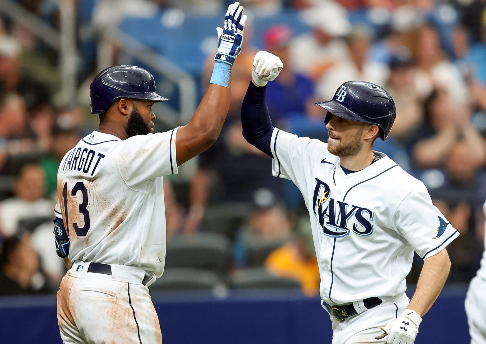 Manuel Margot #13 of the Tampa Bay Rays congratulates Brandon Lowe #8 after his two-run home run against the Oakland Athletics in the seventh inning of a baseball game at Tropicana Field on April 14, 2022 in St. Petersburg, Florida.