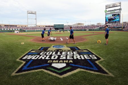 Members of the ground ready the field before the start of the Vanderbilt Commodores and Mississippi St. Bulldogs game three of the College World Series Championship at TD Ameritrade Park Omaha on June 30, 2021 in Omaha, Nebraska.