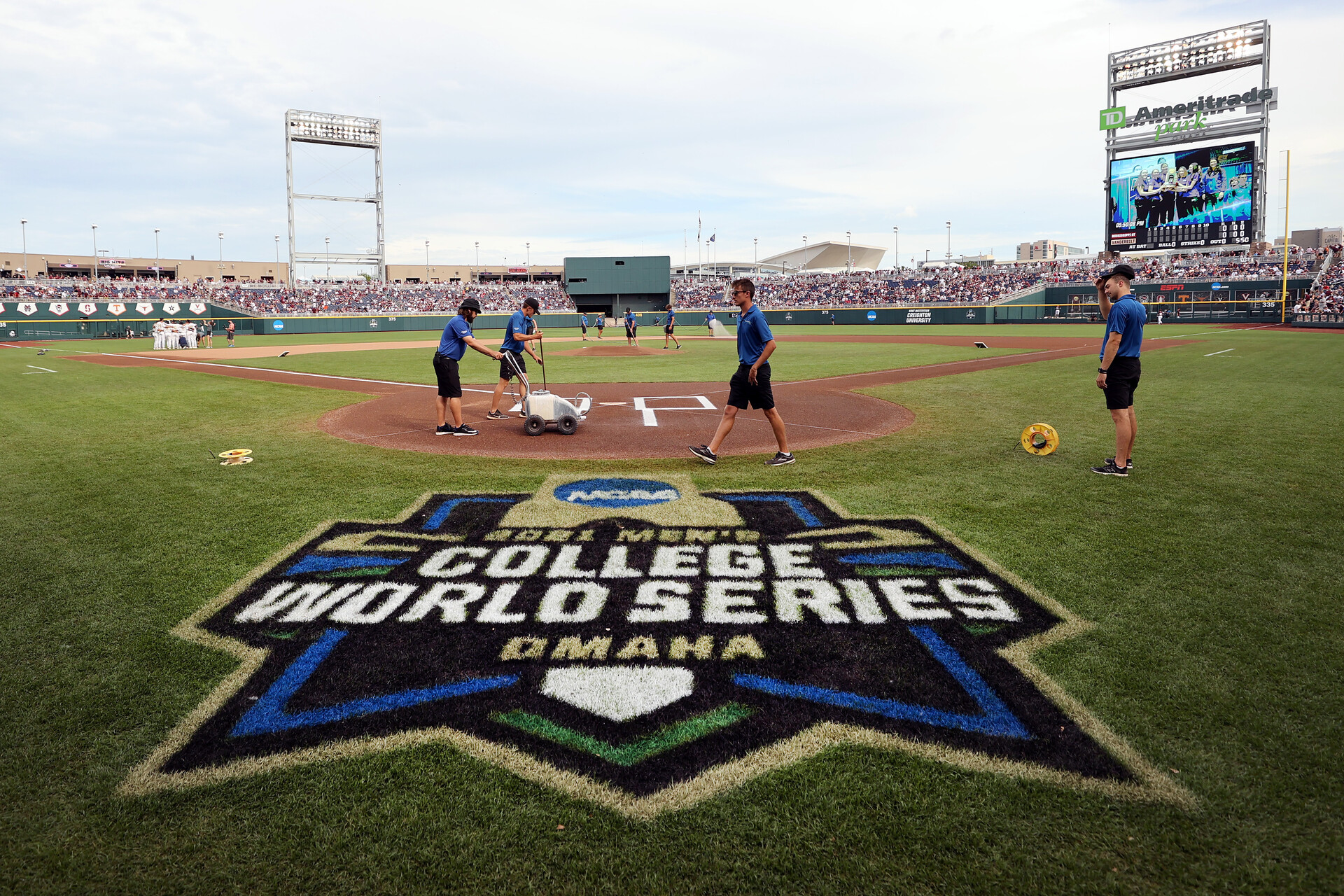 Members of the ground ready the field before the start of the Vanderbilt Commodores and Mississippi St. Bulldogs game three of the College World Series Championship at TD Ameritrade Park Omaha on June 30, 2021 in Omaha, Nebraska.