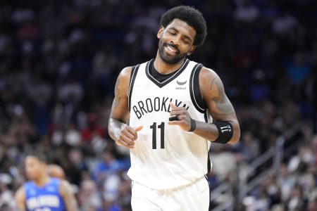 Kyrie Irving #11 of the Brooklyn Nets reacts after scoring against the Orlando Magic in the second half at Amway Center on March 15, 2022 in Orlando, Florida