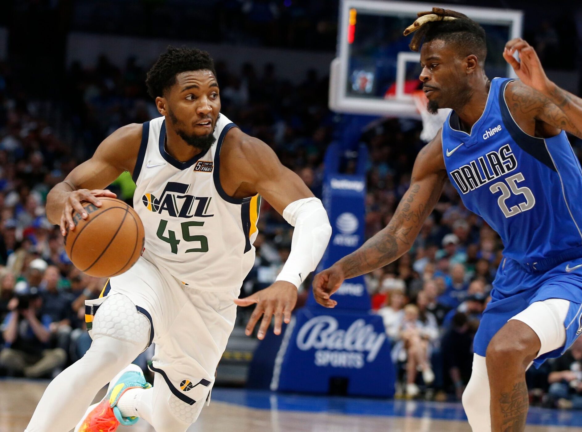 Donovan Mitchell #45 of the Utah Jazz drives to the basket against Reggie Bullock #25