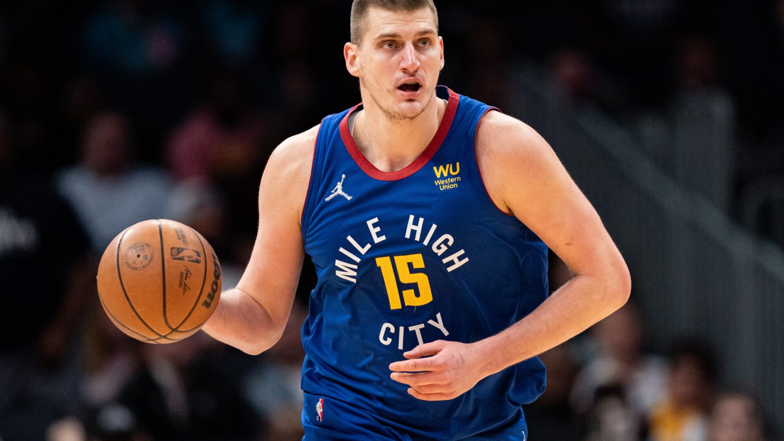 Nikola Jokic #15 of the Denver Nuggets brings the ball up court against the Charlotte Hornets during their game at Spectrum Center on March 28, 2022