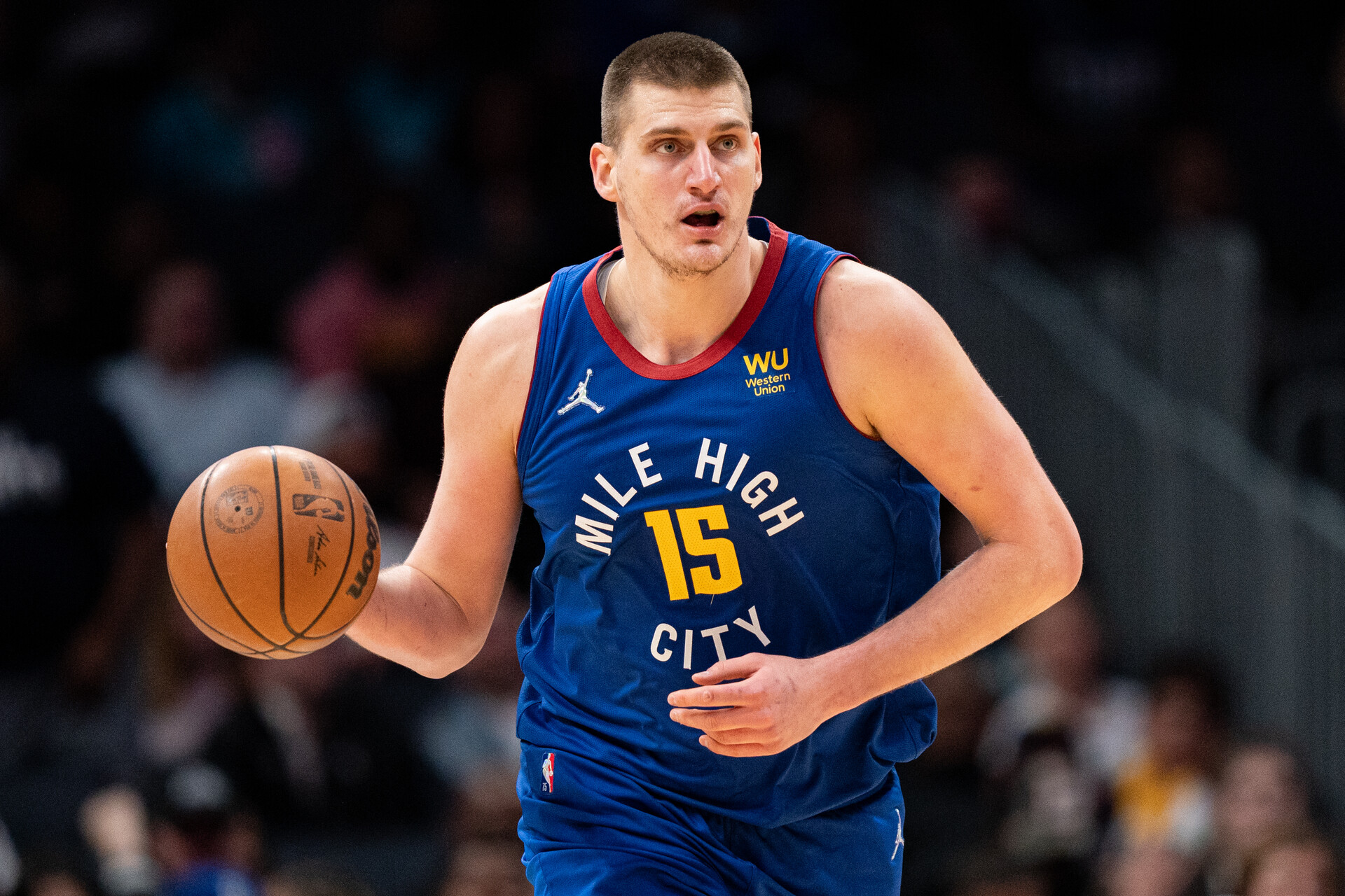 Nikola Jokic #15 of the Denver Nuggets brings the ball up court against the Charlotte Hornets during their game at Spectrum Center on March 28, 2022