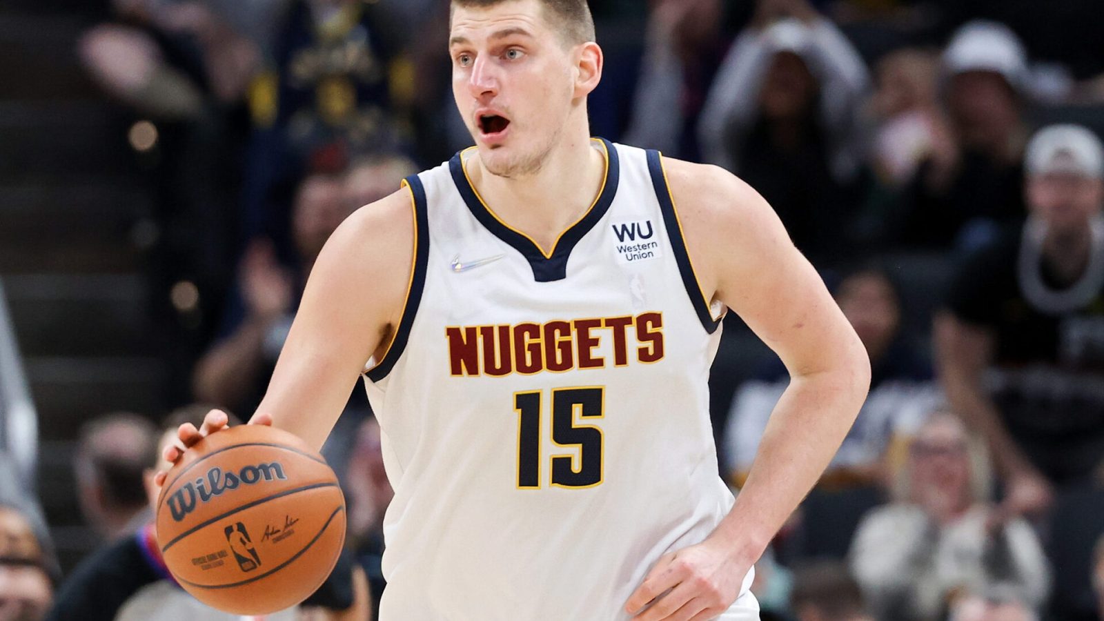 Nikola Jokic #15 of the Denver Nuggets dribbles the ball in the fourth quarter against the Indiana Pacers at Gainbridge Fieldhouse on March 30, 2022 in Indianapolis, Indiana.