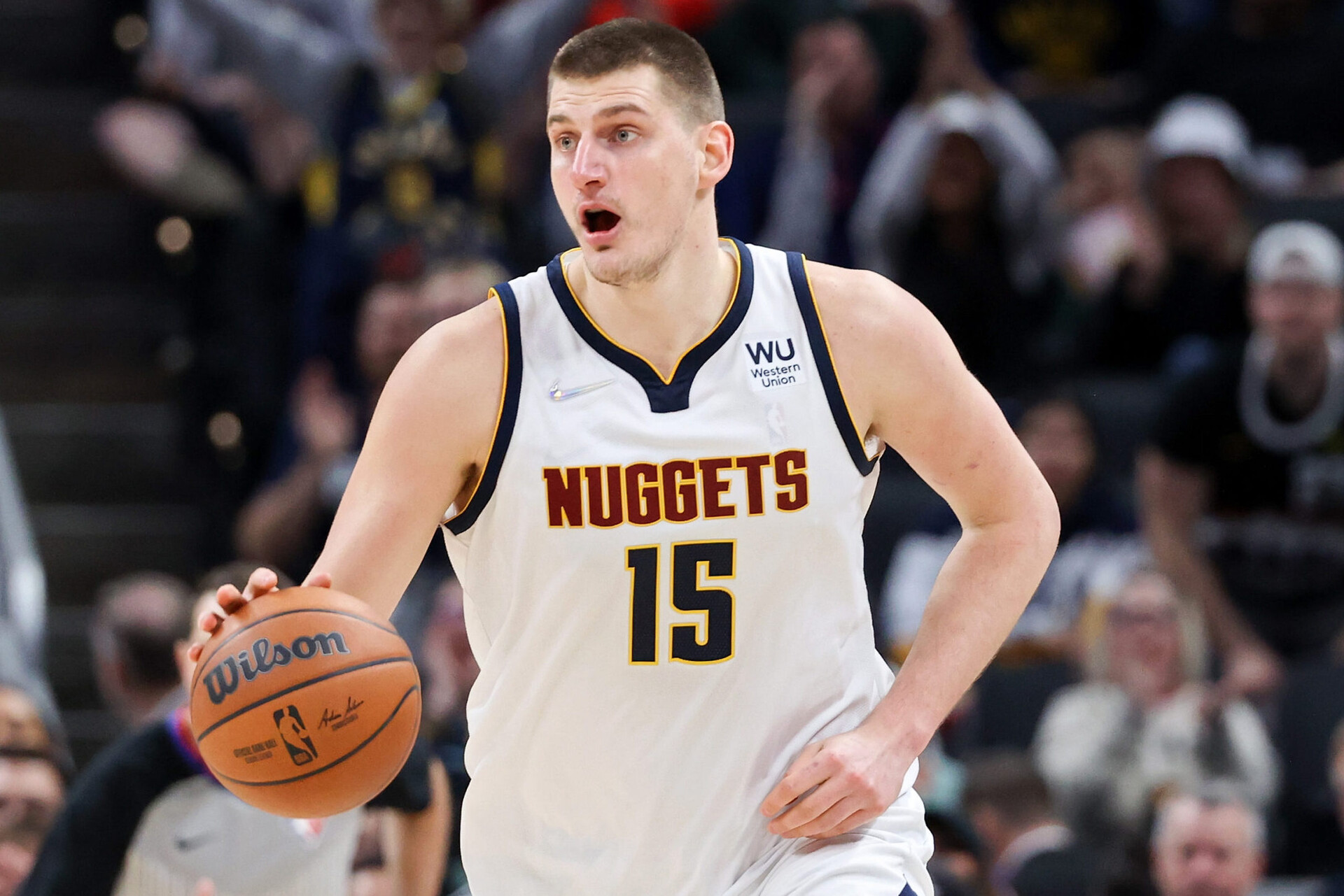 Nikola Jokic #15 of the Denver Nuggets dribbles the ball in the fourth quarter against the Indiana Pacers at Gainbridge Fieldhouse on March 30, 2022 in Indianapolis, Indiana.