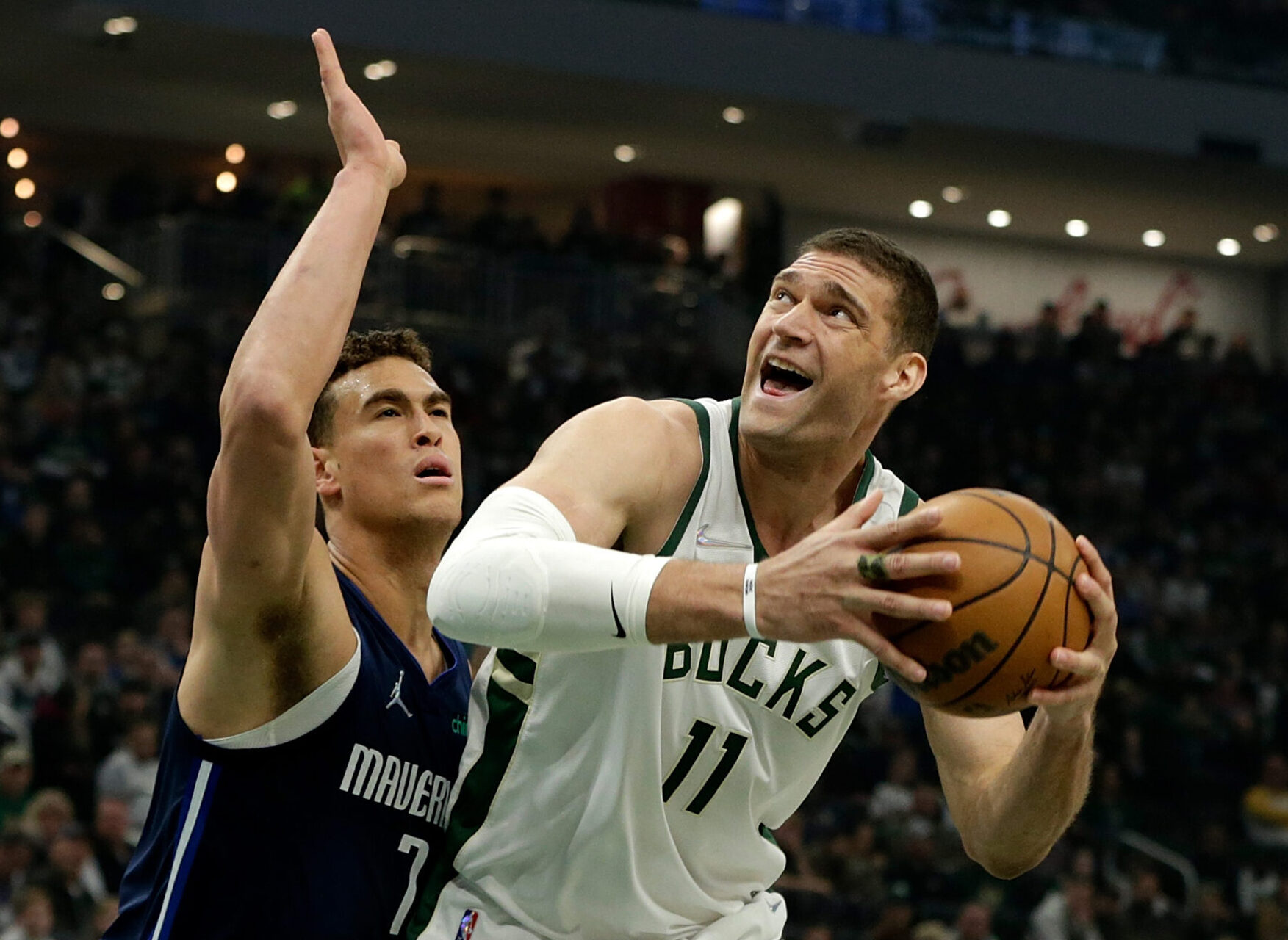 Brook Lopez #11 of the Milwaukee Bucks goes up for a shot on Dwight Powell #7 of the Dallas Mavericks during the first half of a game at Fiserv Forum on April 03, 2022 in Milwaukee, Wisconsin.