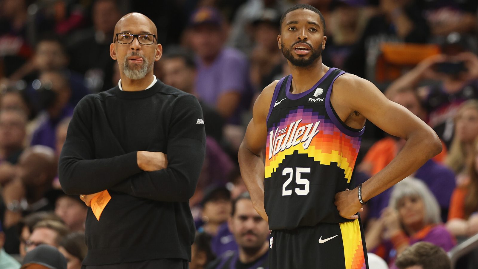 Head coach Monty Williams (left) and Mikal Bridges (right) of the Phoenix Suns look on during the second half of Game One of the Western Conference First Round NBA Playoffs at Footprint Center on April 17, 2022 in Phoenix, Arizona. The Suns defeated the Pelicans 110-109.