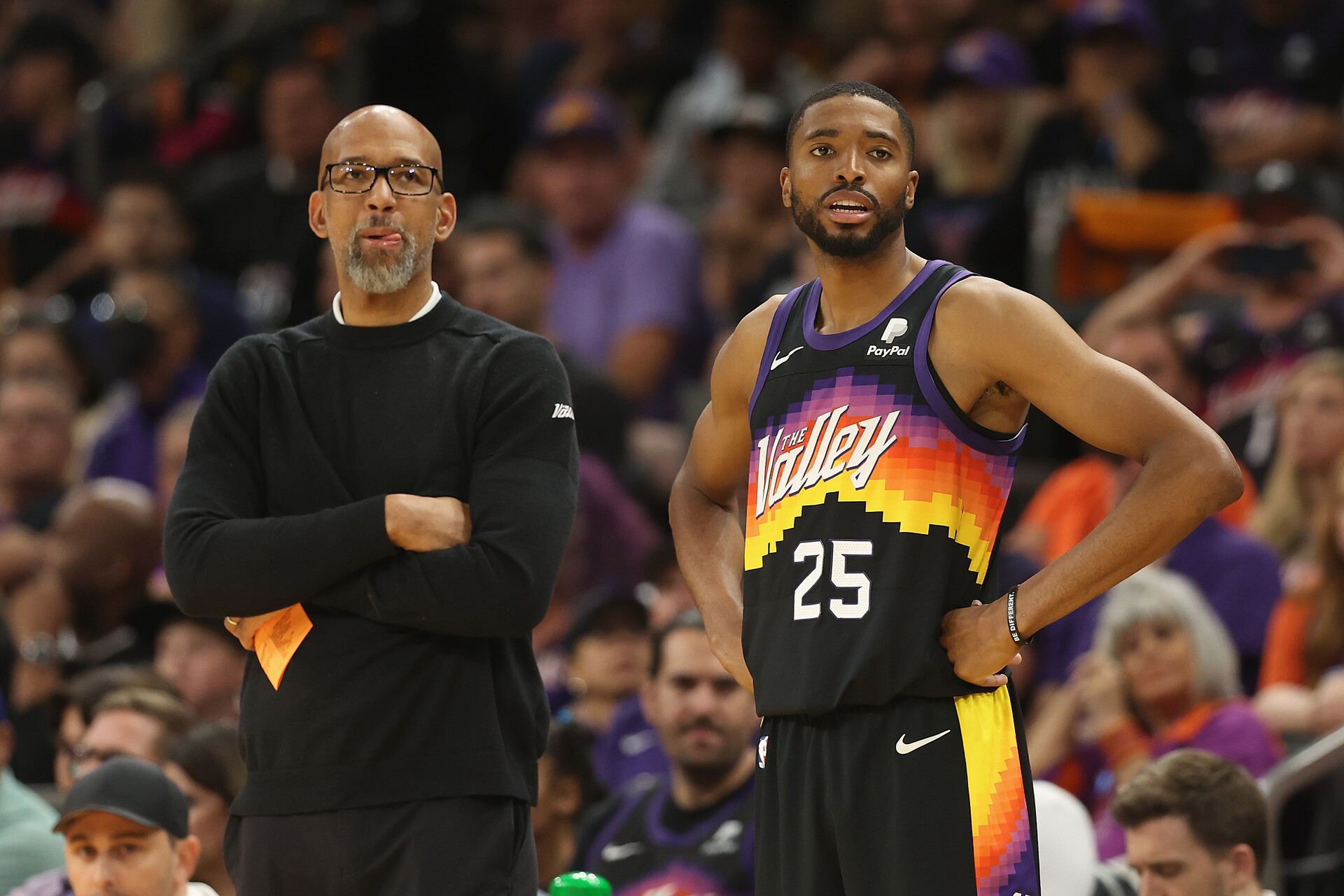 Head coach Monty Williams (left) and Mikal Bridges (right) of the Phoenix Suns look on during the second half of Game One of the Western Conference First Round NBA Playoffs at Footprint Center on April 17, 2022 in Phoenix, Arizona. The Suns defeated the Pelicans 110-109.