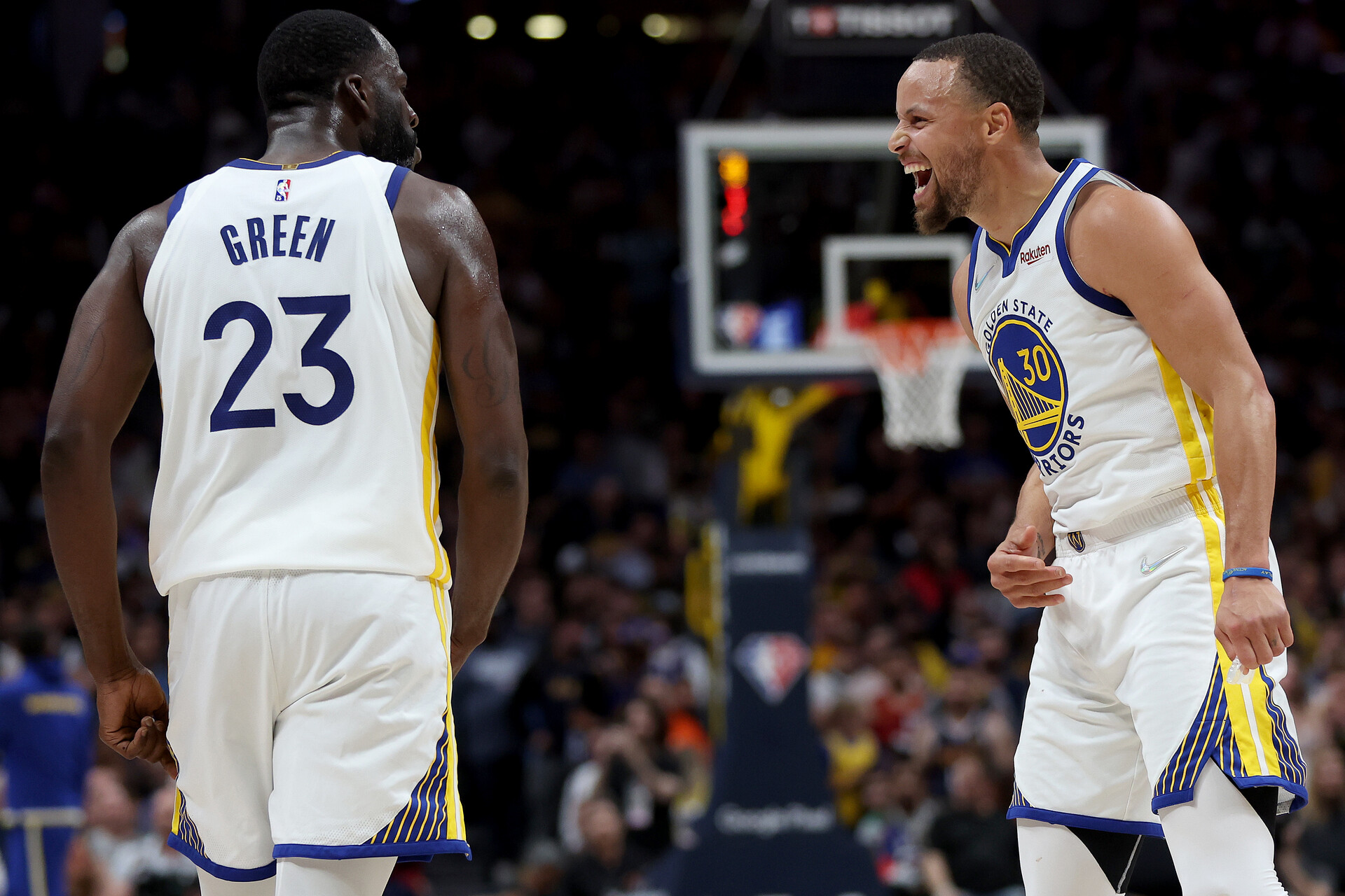 Golden State Warriors Draymond Green, left, and Stephen Curry look at each other in celebration during their victory over the Denver Nuggets on April 21, 2022, in Denver.
