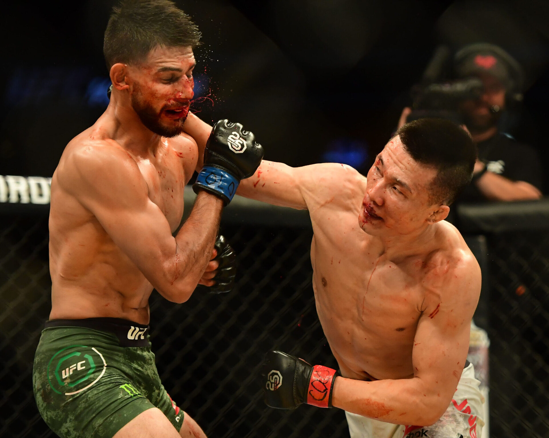 Chan Sung Jung (right) strikes Yair Rodriguez (left) with a looping right hand punch during a UFC Fight Night event