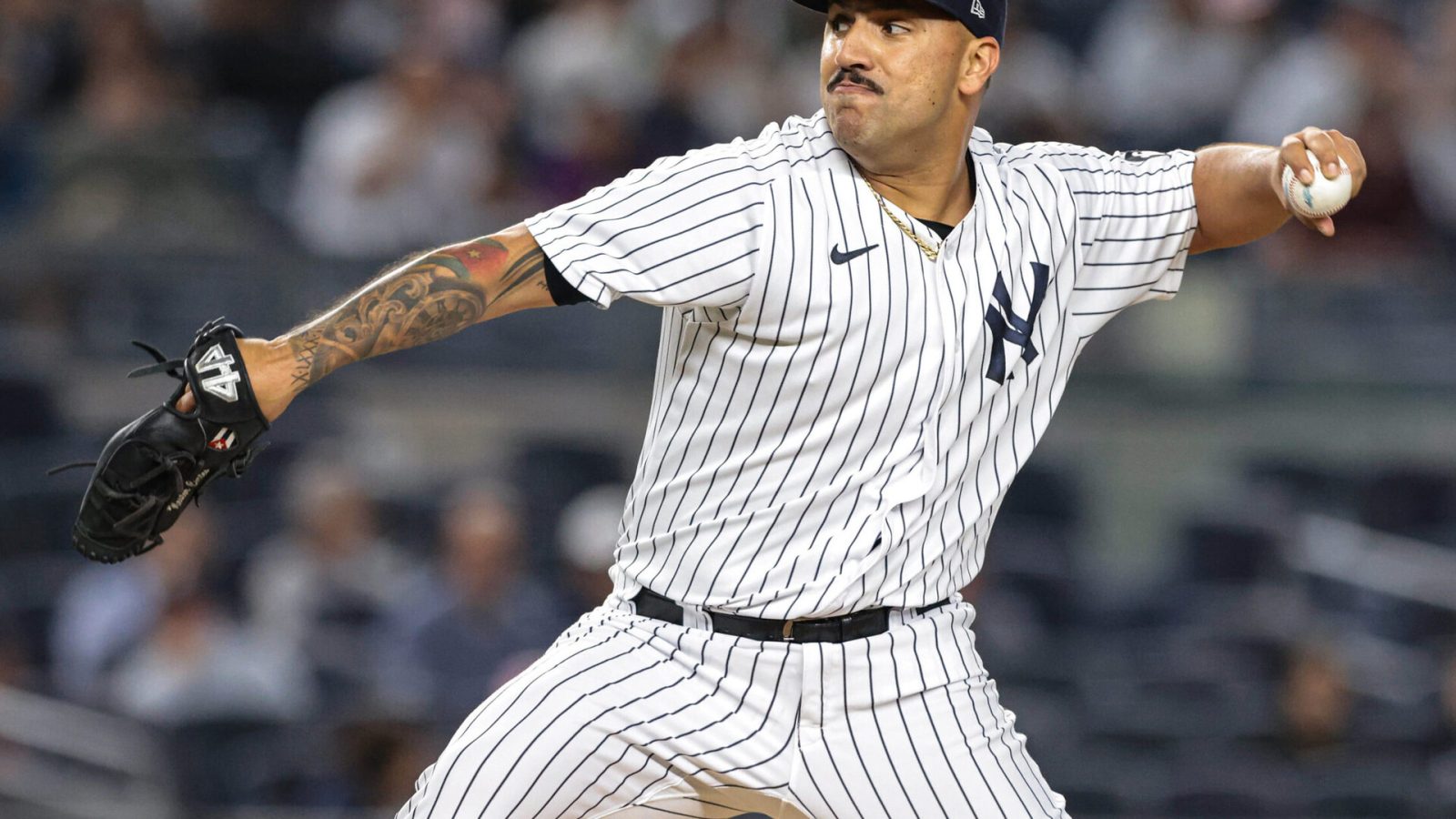 New York Yankees left-handed starting pitcher Nestor Cortes Jr. reaches back and prepares to deliver a pitch against the Texas Rangers