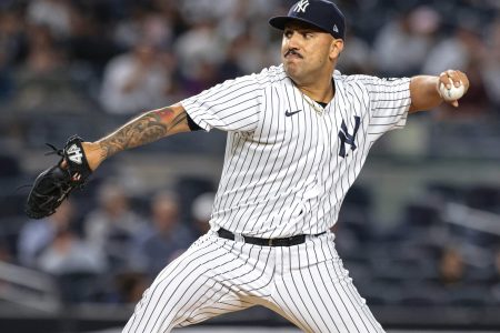 New York Yankees left-handed starting pitcher Nestor Cortes Jr. reaches back and prepares to deliver a pitch against the Texas Rangers