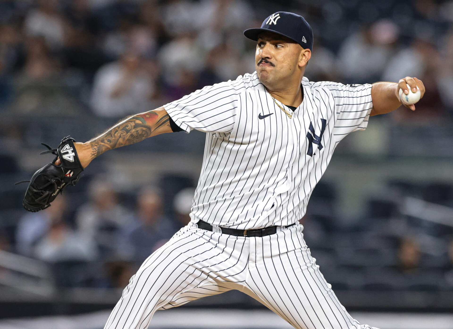 New York Yankees left-handed starting pitcher Nestor Cortes Jr. reaches back and prepares to deliver a pitch against the Texas Rangers