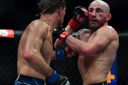 Alexander Volkanovski defends against Brian Ortega during UFC 266 at T-Mobile Arena.
