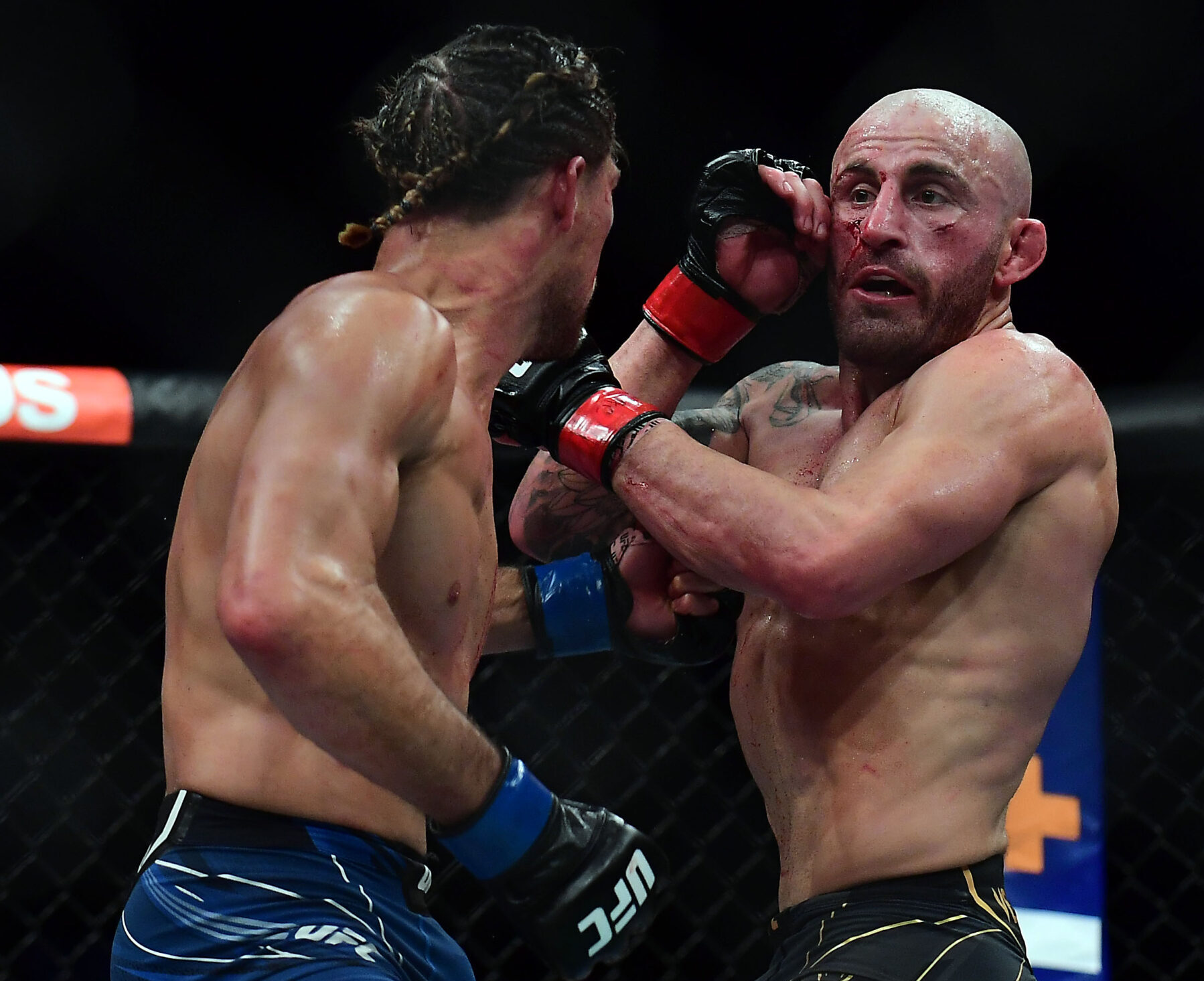 Alexander Volkanovski defends against Brian Ortega during UFC 266 at T-Mobile Arena.