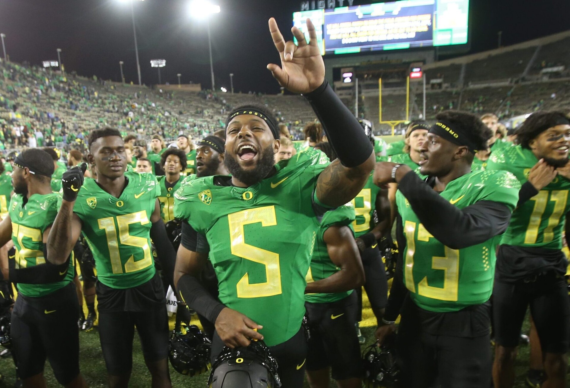 Oregon's Kayvon Thibodeaux, center, celebrates with teammates after the win over Arizona in their first Pac-12 game of the 2021-22 season.