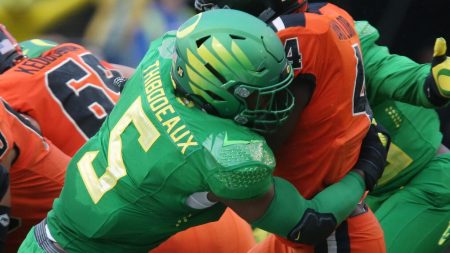 Oregon pass rusher Kayvon Thibodeaux, left, making a tackle against Oregon State during the 2020-21 season, is projected to be one of the top picks in the 2022 NFL Draft.