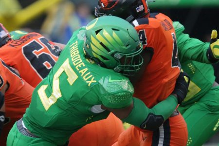 Oregon pass rusher Kayvon Thibodeaux, left, making a tackle against Oregon State during the 2020-21 season, is projected to be one of the top picks in the 2022 NFL Draft.