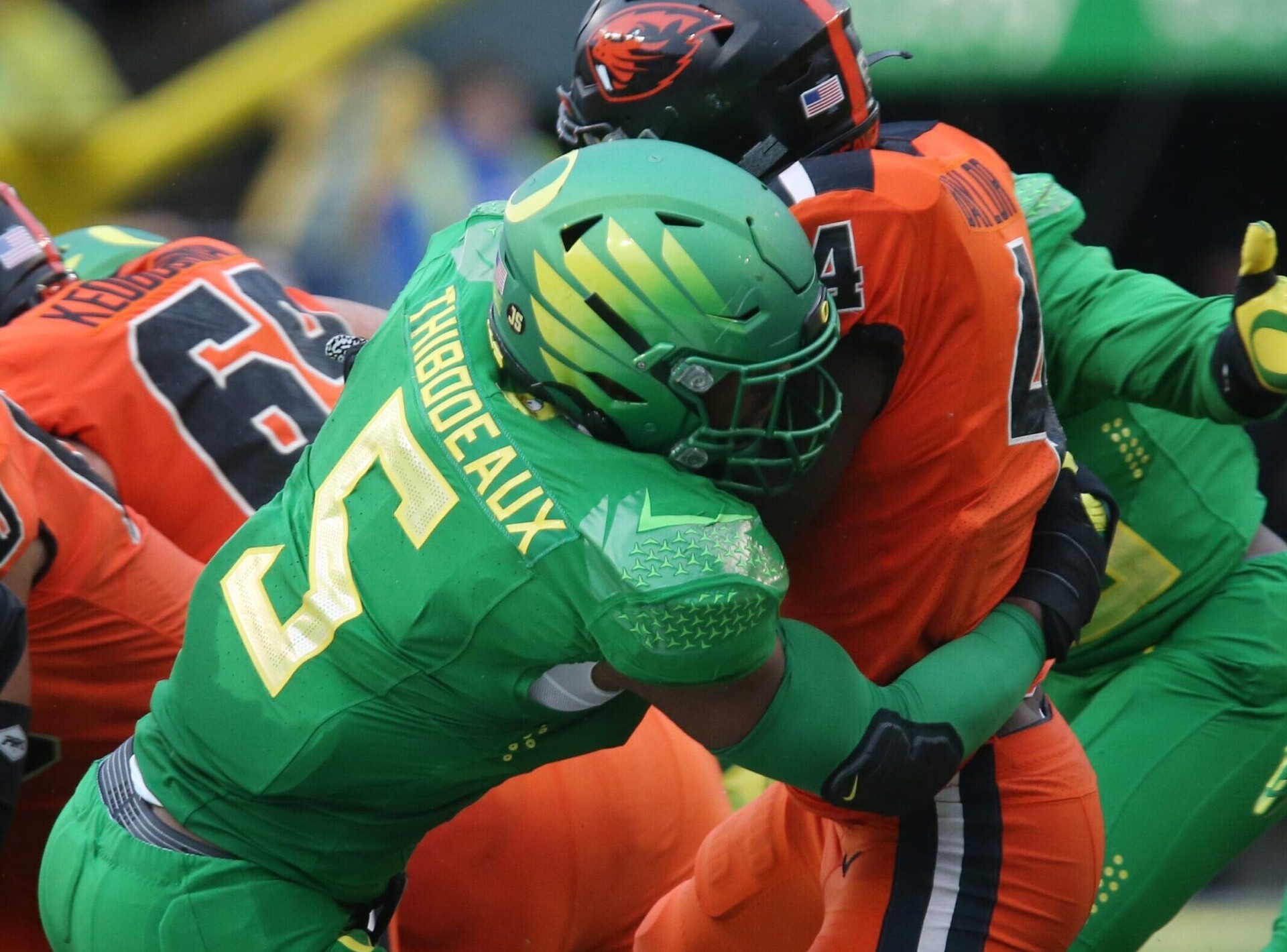 Oregon pass rusher Kayvon Thibodeaux, left, making a tackle against Oregon State during the 2020-21 season, is projected to be one of the top picks in the 2022 NFL Draft.