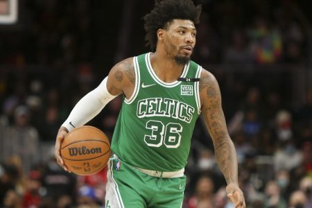 Boston Celtics guard Marcus Smart dribbles the basketball up court with his right hand during a game against the Atlanta Hawks