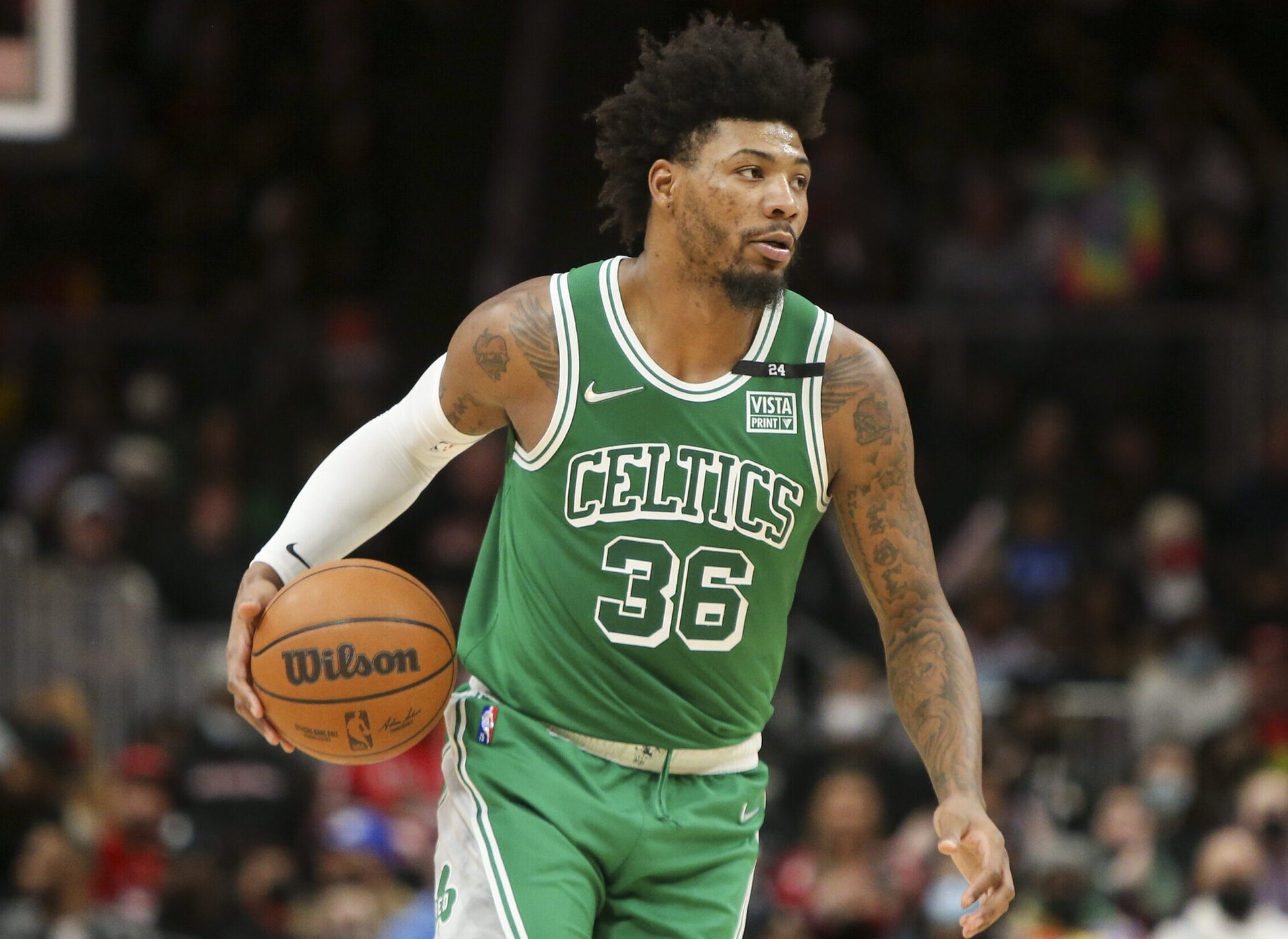 Boston Celtics guard Marcus Smart dribbles the basketball up court with his right hand during a game against the Atlanta Hawks