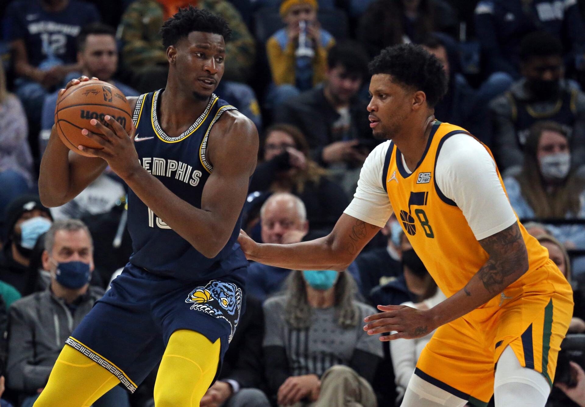 Memphis Grizzles forward Jaren Jackson Jr. (left) clutches the basketball with both hands while Utah Jazz forward-guard Rudy Gay (right) defends