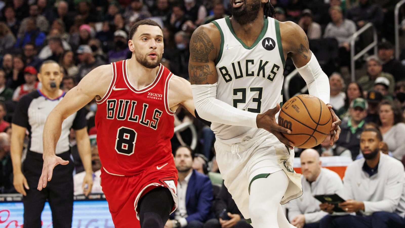 Milwaukee Bucks guard Wesley Matthews (right) holds the basketball with both hands as he drives past Chicago Bulls guard Zach LaVine (left) on his way to the basket