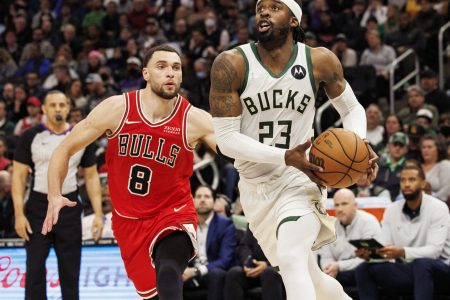 Milwaukee Bucks guard Wesley Matthews (right) holds the basketball with both hands as he drives past Chicago Bulls guard Zach LaVine (left) on his way to the basket